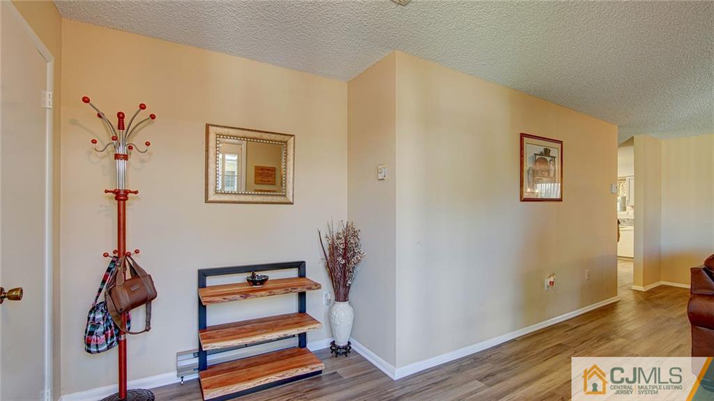 801 A Pompton Road, Unit 801A Monroe Township, NJ 08831 - Photo 4 of 33 a room with gym equipment and wooden floor