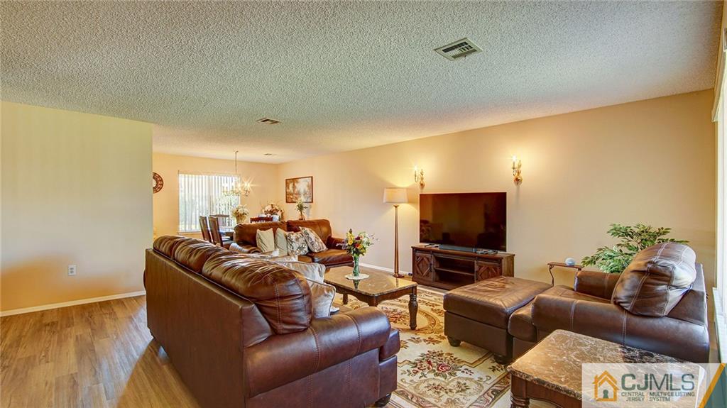 801 A Pompton Road, Unit 801A Monroe Township, NJ 08831 - Photo 5 of 33 a living room with furniture and a flat screen tv