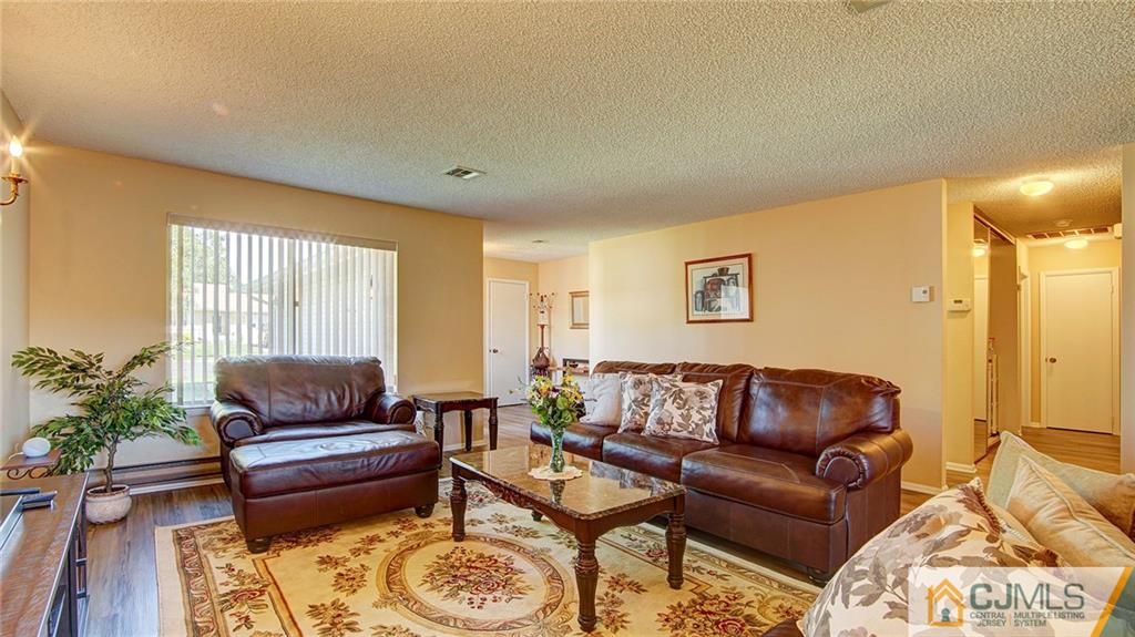 801 A Pompton Road, Unit 801A Monroe Township, NJ 08831 - Photo 8 of 33 a living room with furniture and a potted plant