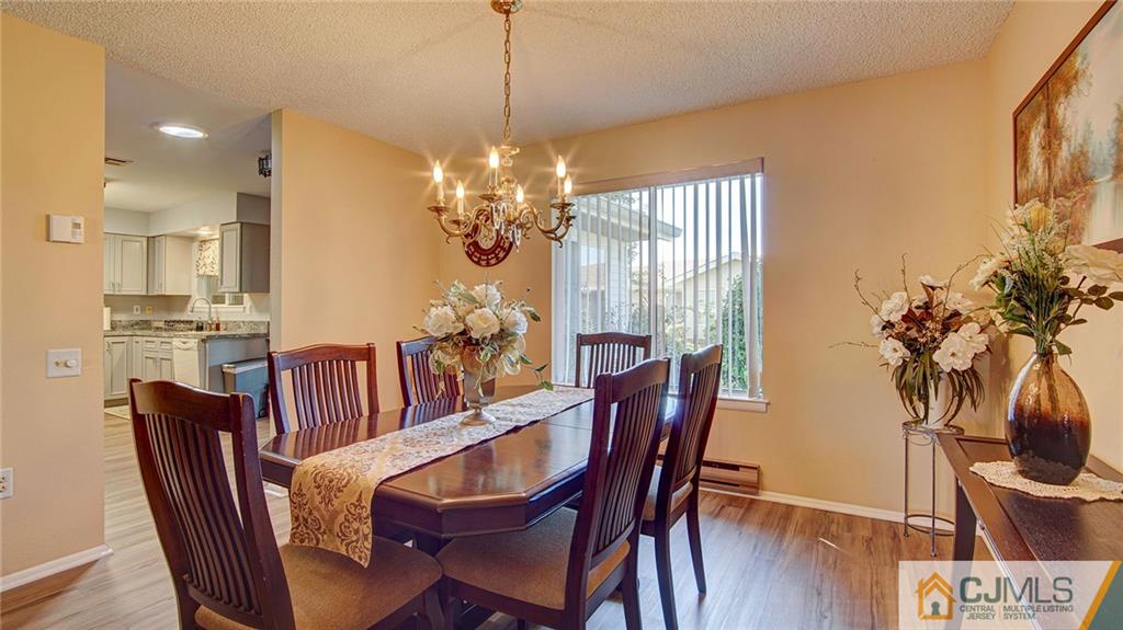 801 A Pompton Road, Unit 801A Monroe Township, NJ 08831 - Photo 10 of 33 a view of a dining room with furniture window and wooden floor