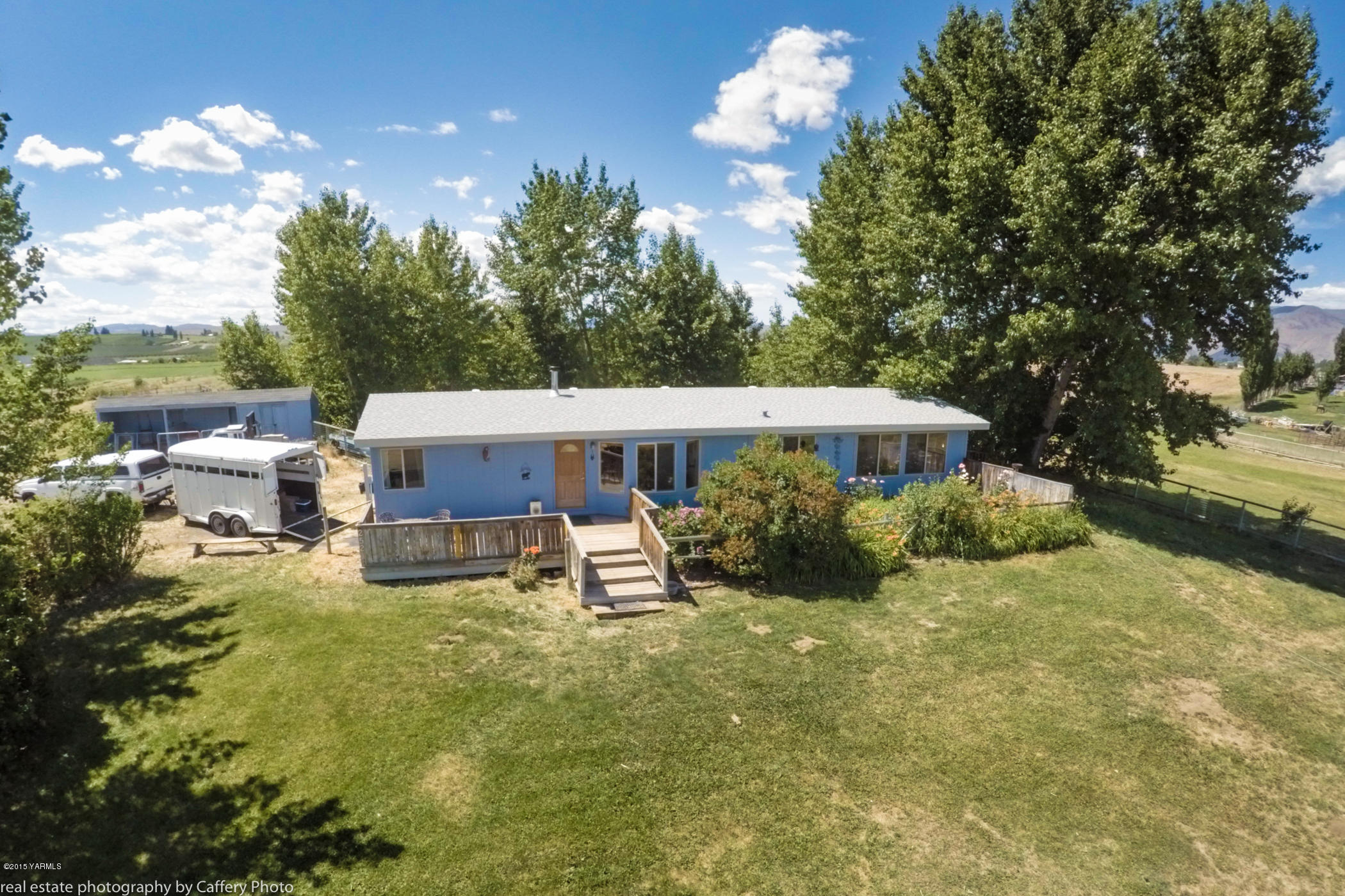 252-250 Knutson Road Tieton, WA 98947 - Photo 3 of 51 a view of a house with backyard sitting area and garden
