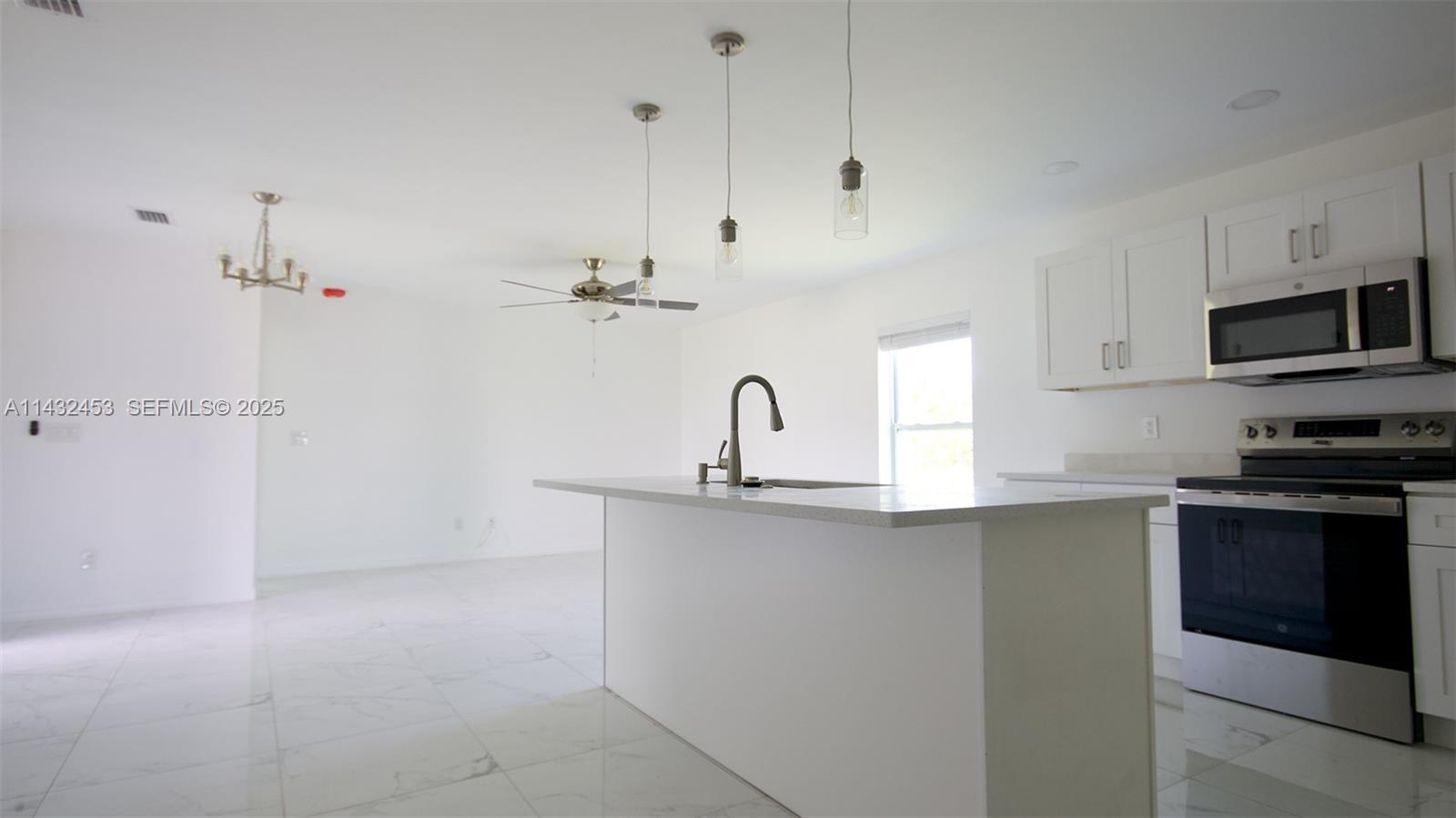 3433 Jeffcott Street Fort Myers, FL 33916 - Photo 16 of 41 a kitchen with a sink and cabinets
