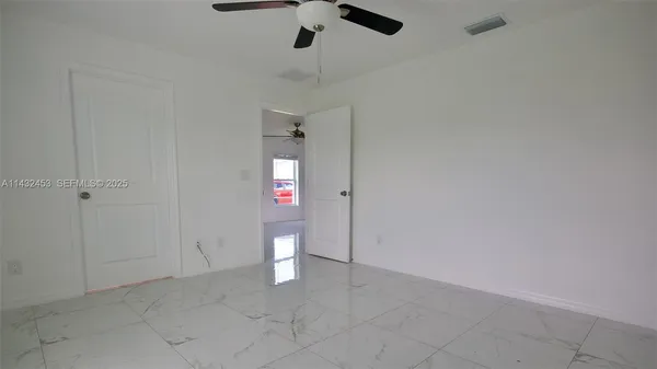 a white toilet sitting next to a shower