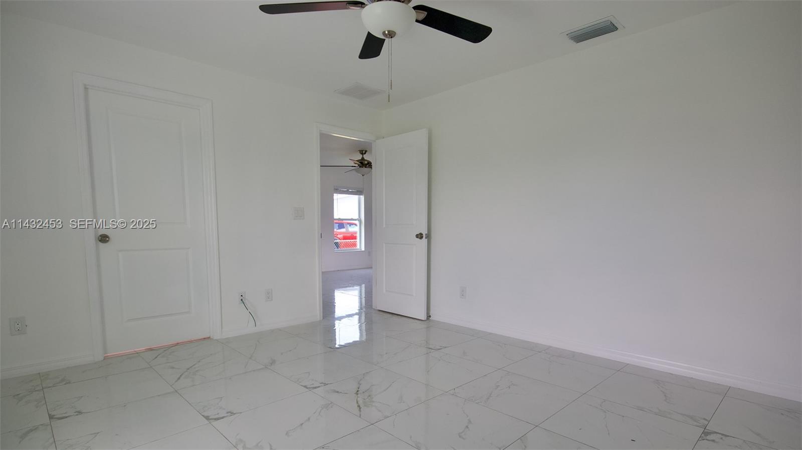 3433 Jeffcott Street Fort Myers, FL 33916 - Photo 24 of 41 an empty room with white walls and ceiling fan