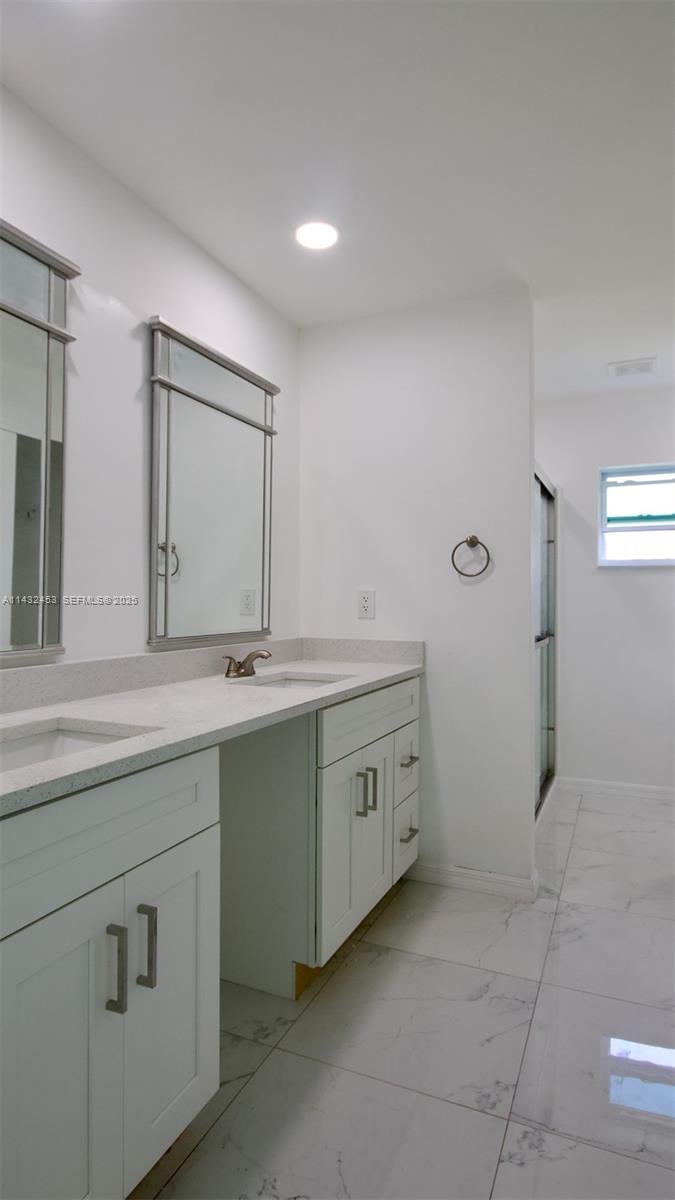 3433 Jeffcott Street Fort Myers, FL 33916 - Photo 25 of 41 a bathroom with a double vanity sink and mirror