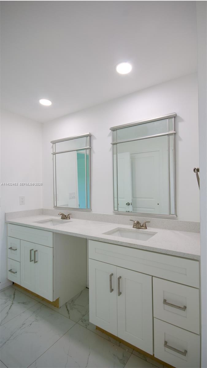 3433 Jeffcott Street Fort Myers, FL 33916 - Photo 26 of 41 a bathroom with a granite countertop sink double and mirror