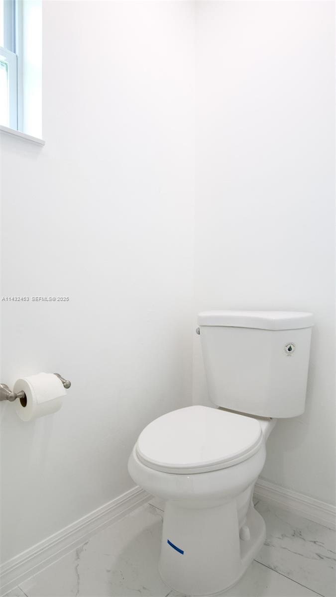 3433 Jeffcott Street Fort Myers, FL 33916 - Photo 27 of 41 a white toilet sitting next to a shower