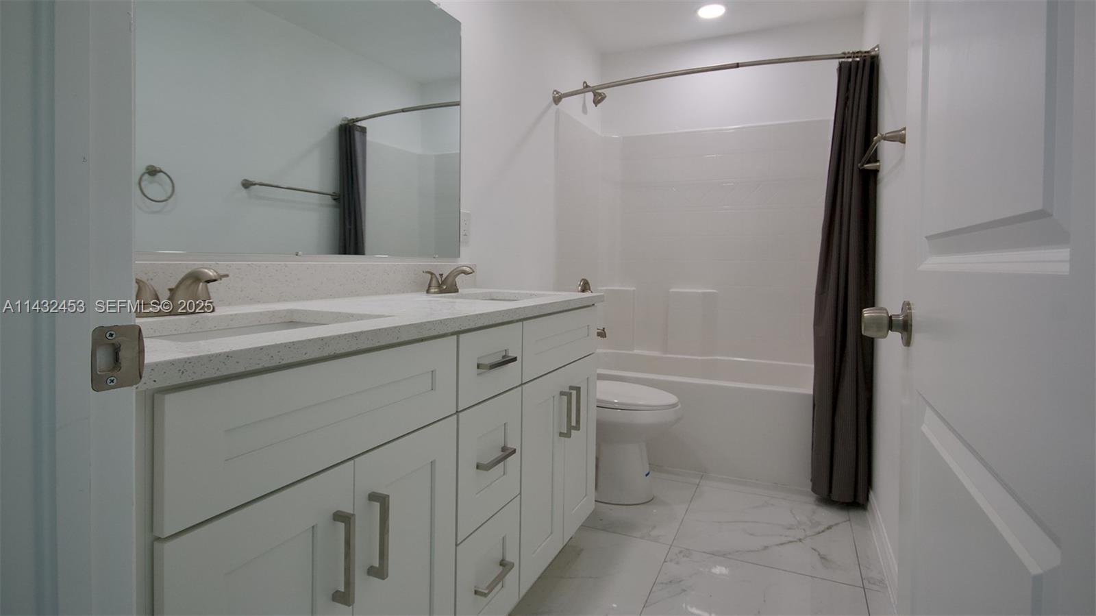 3433 Jeffcott Street Fort Myers, FL 33916 - Photo 39 of 41 a bathroom with a double vanity sink toilet and shower