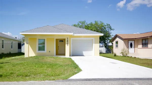 a yellow house with trees in front of it