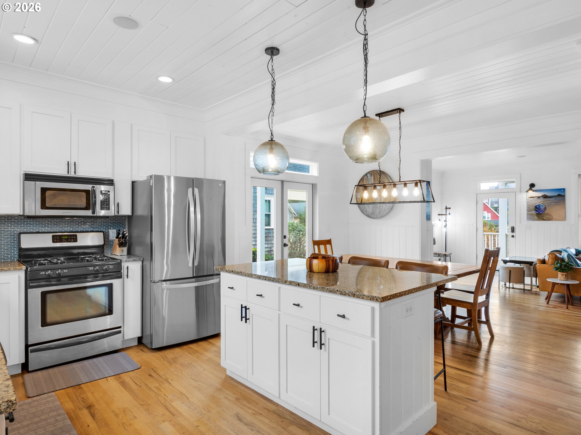 2746 Southwest Barnacle Avenue Lincoln City, OR 97367 - Photo 11 of 48 a kitchen with stainless steel appliances granite countertop a refrigerator a stove and a wooden floors
