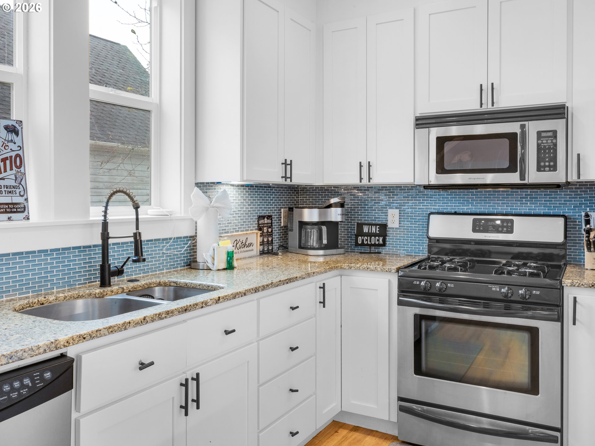 2746 Southwest Barnacle Avenue Lincoln City, OR 97367 - Photo 13 of 48 a kitchen with white cabinets and appliances