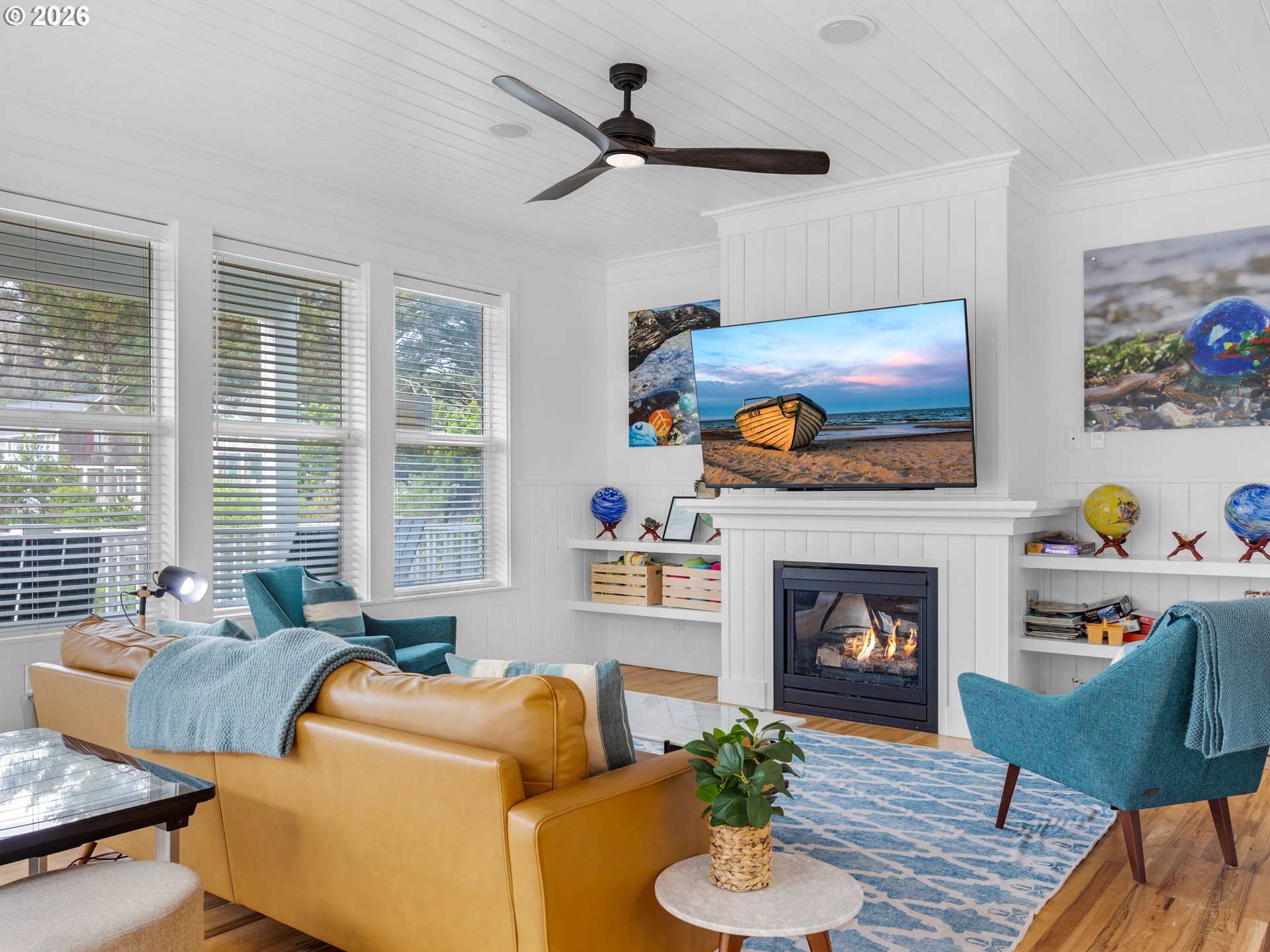 2746 Southwest Barnacle Avenue Lincoln City, OR 97367 - Photo 6 of 48 a living room with furniture a flat screen tv and a fireplace