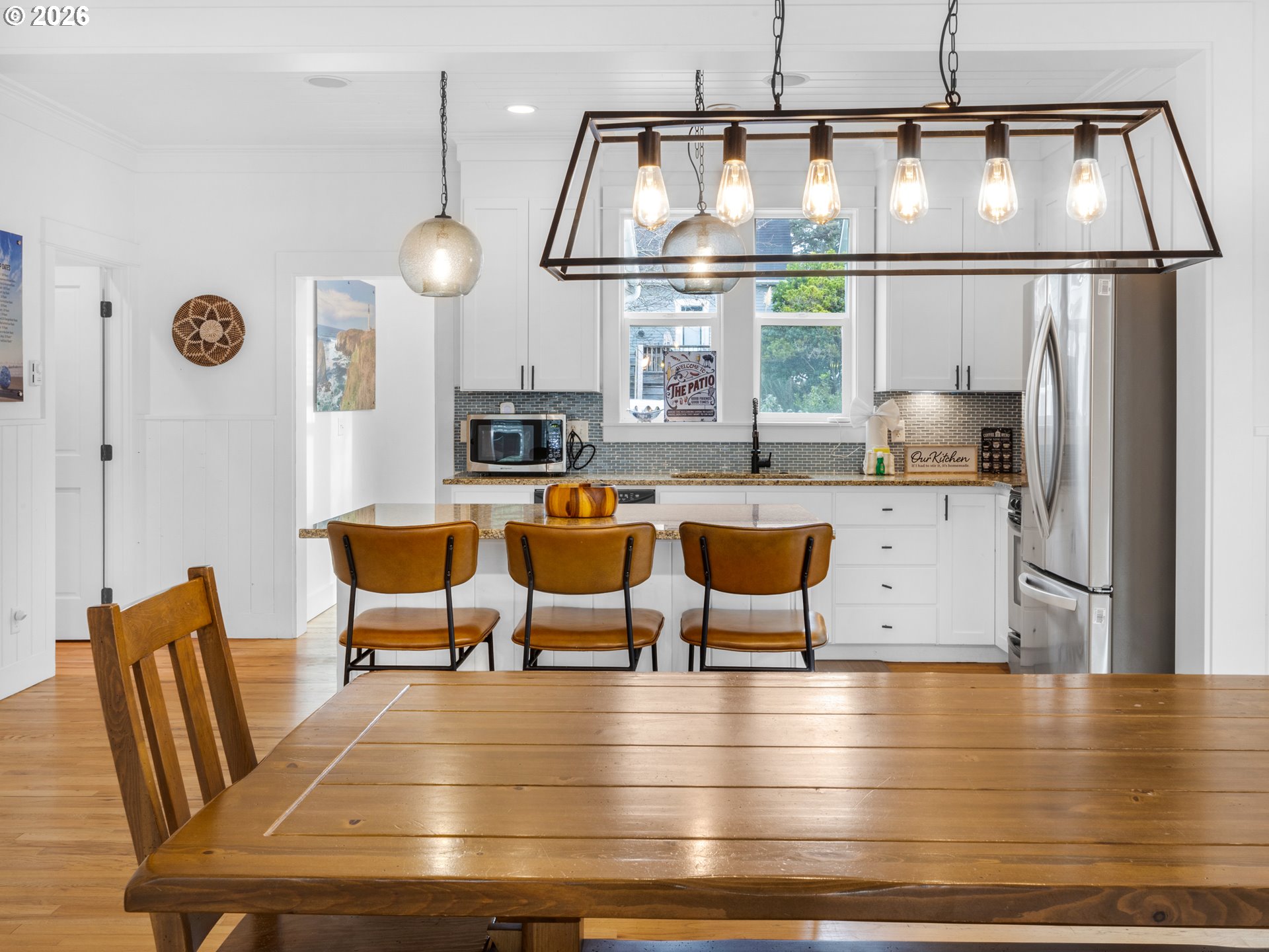 2746 Southwest Barnacle Avenue Lincoln City, OR 97367 - Photo 9 of 48 a view of a dining room with furniture a chandelier and wooden floor