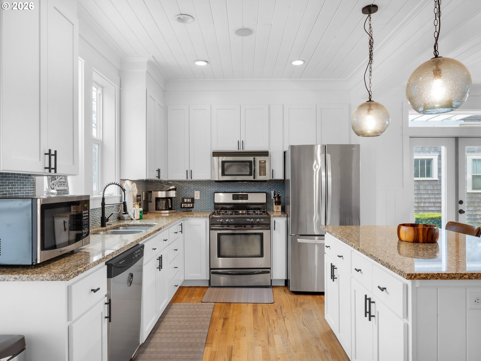 2746 Southwest Barnacle Avenue Lincoln City, OR 97367 - Photo 10 of 48 a kitchen with stainless steel appliances a stove a sink a refrigerator a center island and cabinets