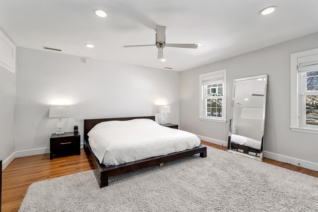 448 Quinobequin Road Newton, MA 02468 - Photo 18 of 35 a spacious bedroom with a bed and a window