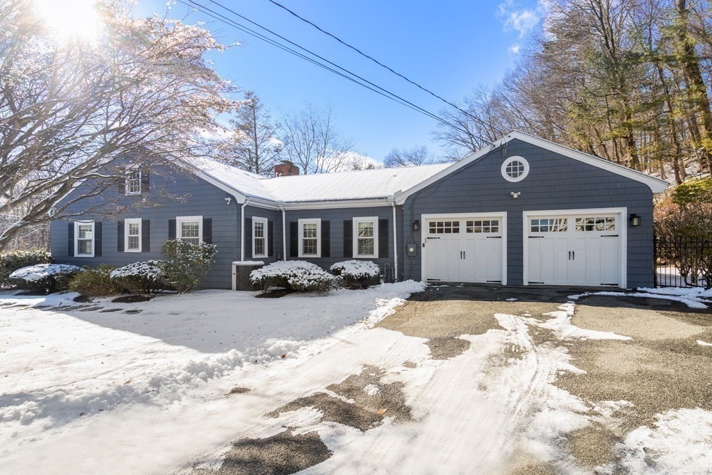 448 Quinobequin Road Newton, MA 02468 - Photo 28 of 35 a front view of a house with a yard covered in snow