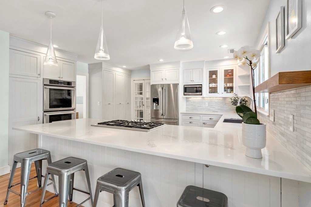 448 Quinobequin Road Newton, MA 02468 - Photo 6 of 35 a kitchen with cabinets and chairs