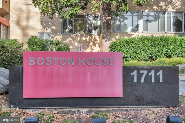 a sign that is on a brick wall