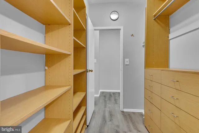 wooden floor in an empty room with a kitchen