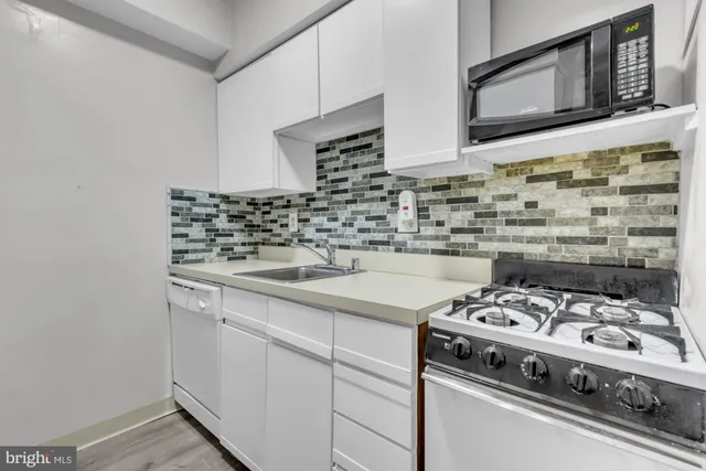 a kitchen with stainless steel appliances granite countertop a refrigerator and a stove