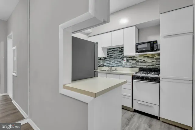 a utility room with a wooden floor