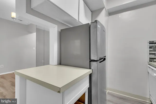 a view of a kitchen with a sink and dishwasher wooden floor