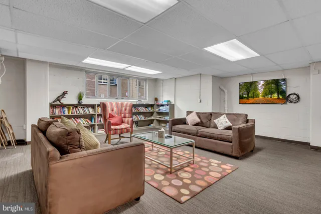 a view of a workspace with furniture and lounge chair