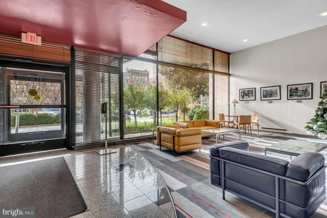 a living room with furniture and large windows