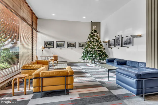 a living room with furniture and a potted plant