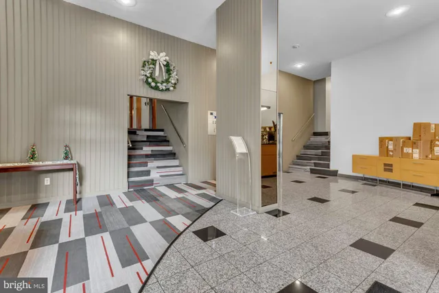 a view of a hallway with workspace and windows