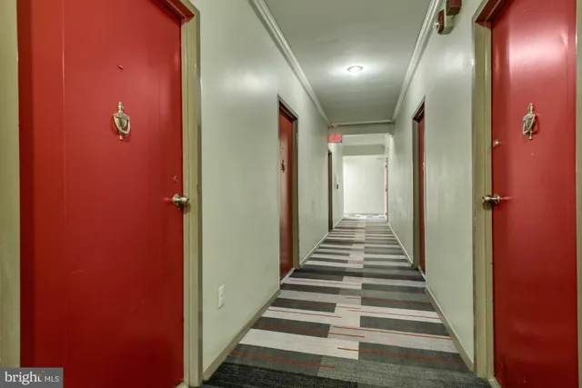 a view of a hallway with wooden floor
