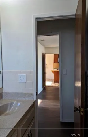 a view of a kitchen from a hallway