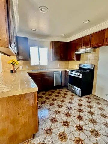a kitchen with kitchen island sink refrigerator and microwave