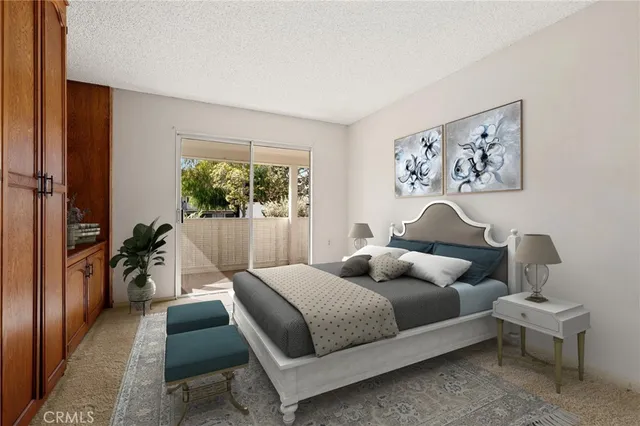 a bedroom with a bed and a painting on the wall