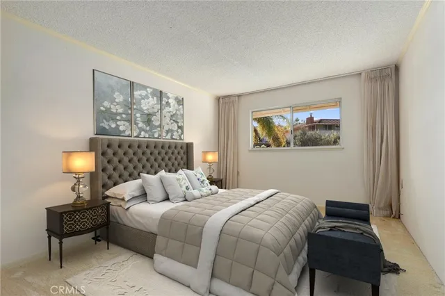 a bedroom with a bed and a lamp on table