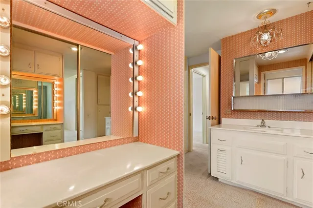 a bathroom with a sink a vanity and a mirror