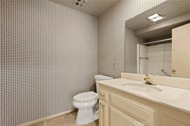 a bathroom with a sink a toilet and mirror