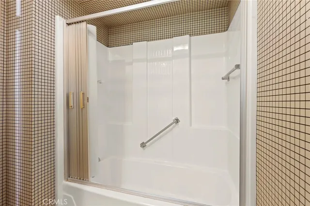 a bathroom with a shower and a glass door