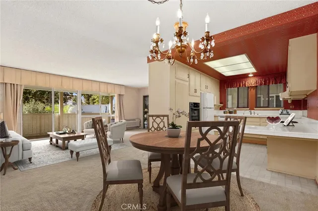 a view of a dining room with furniture and a chandelier