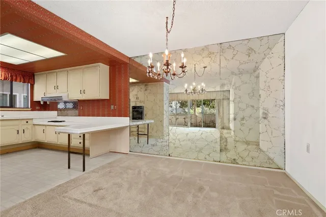 a lobby with furniture and a chandelier