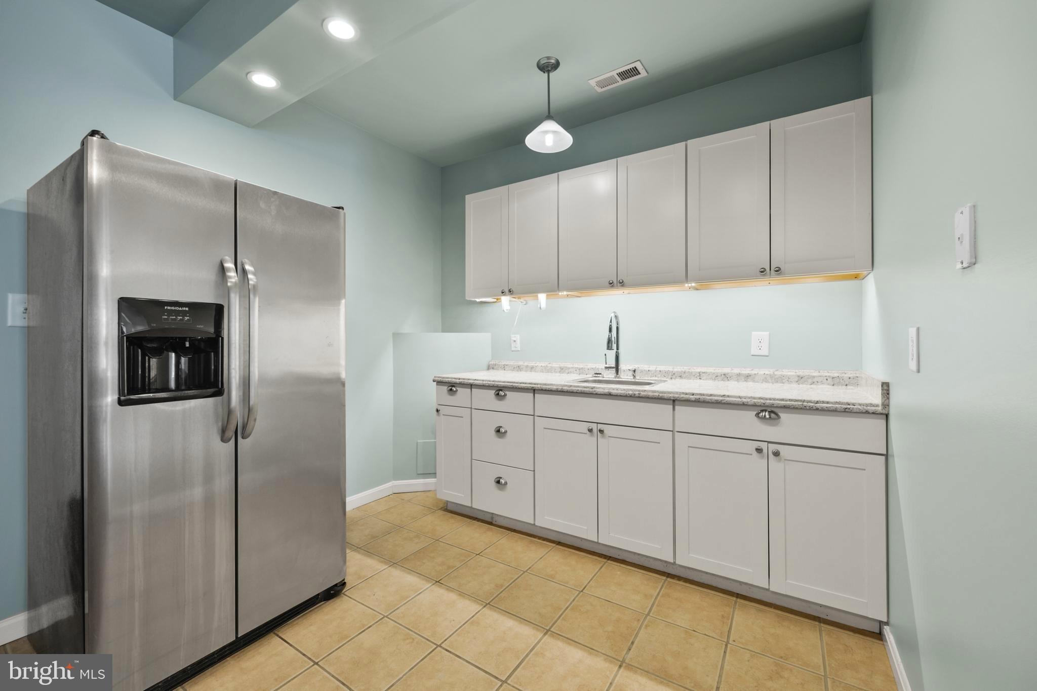 203 Birdie Road Locust Grove, VA 22508 - Photo 36 of 46 a kitchen with stainless steel appliances granite countertop a refrigerator and a sink