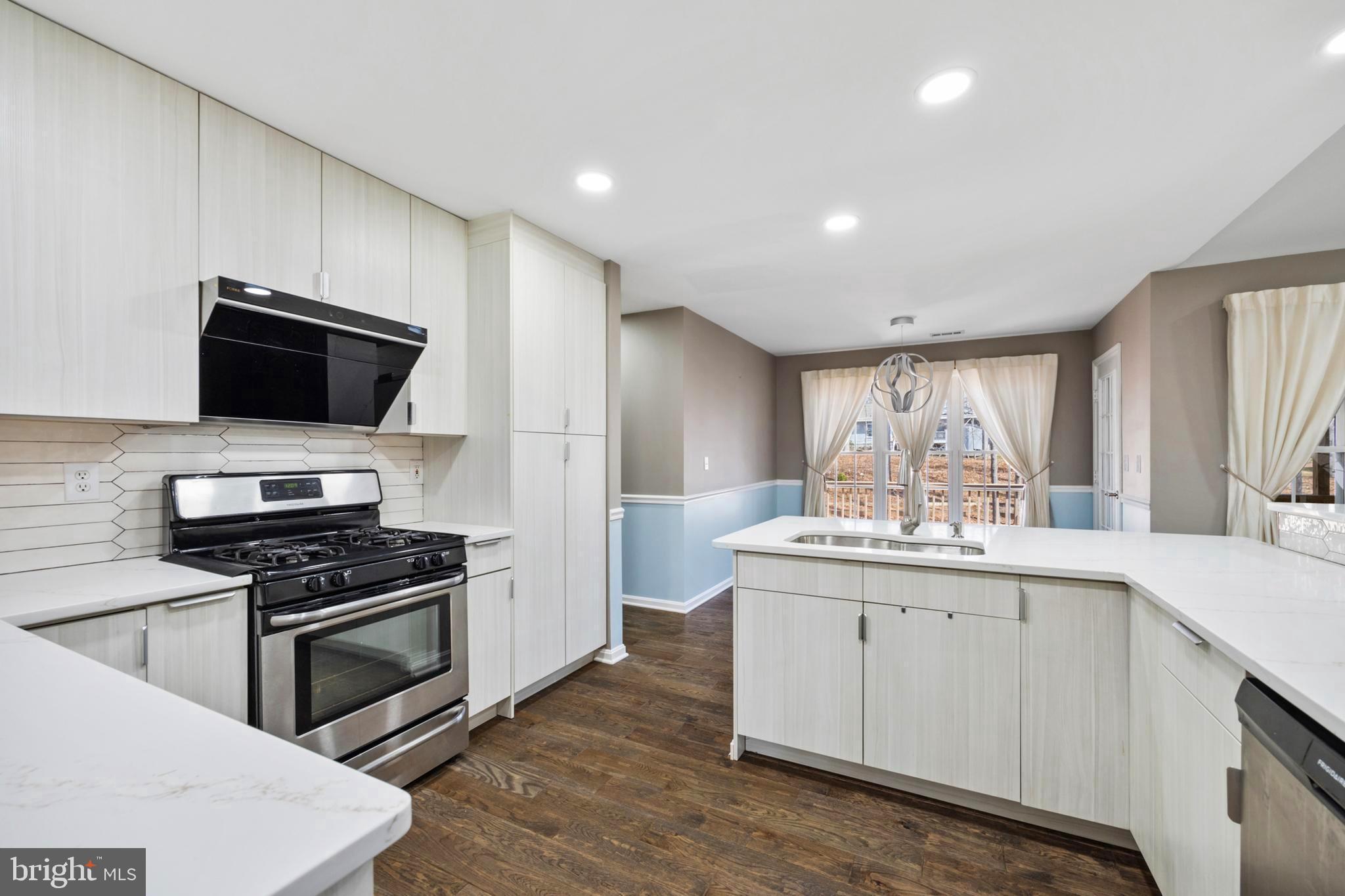 203 Birdie Road Locust Grove, VA 22508 - Photo 7 of 46 a kitchen with granite countertop appliances a sink and cabinets