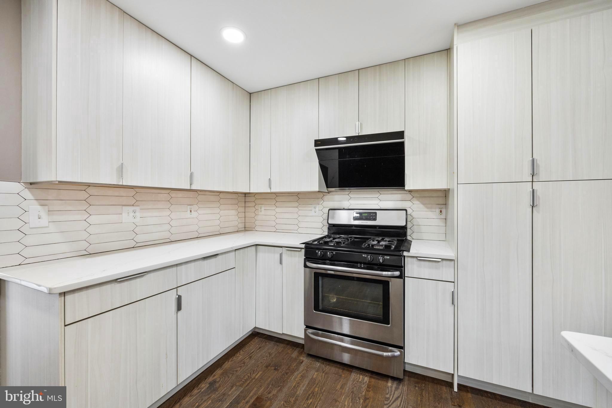 203 Birdie Road Locust Grove, VA 22508 - Photo 8 of 46 a kitchen with cabinets appliances and wooden floor