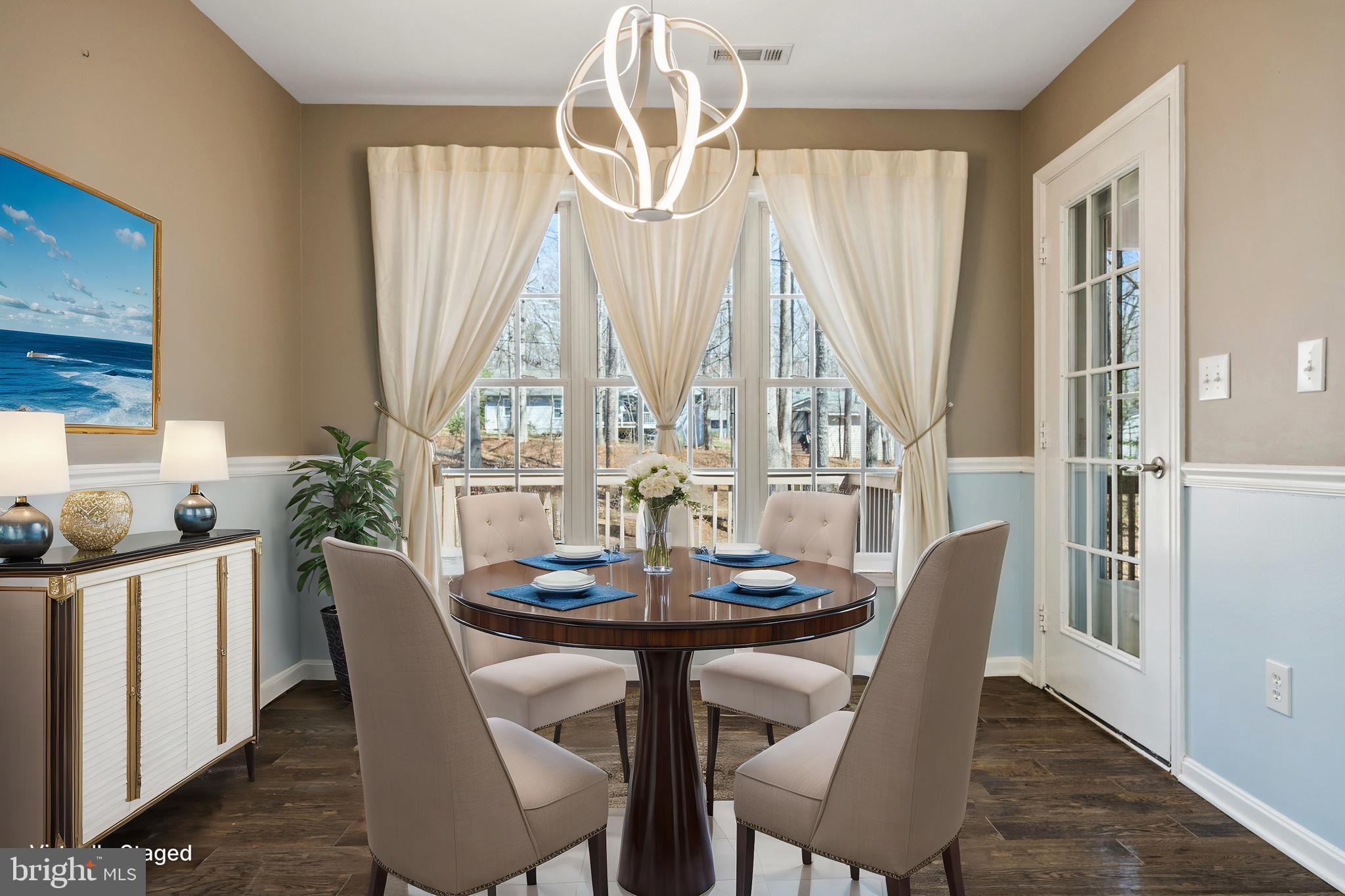 203 Birdie Road Locust Grove, VA 22508 - Photo 9 of 46 a dining room with furniture a chandelier and wooden floor