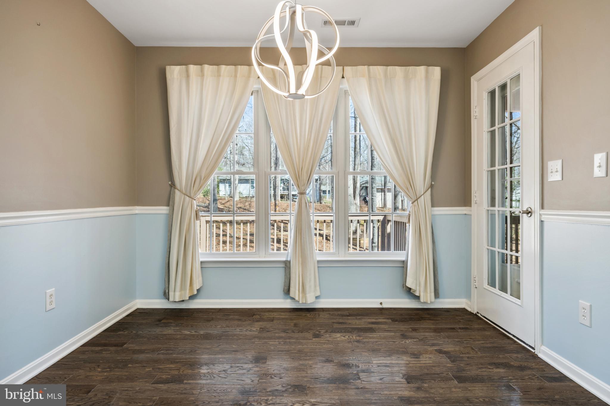 203 Birdie Road Locust Grove, VA 22508 - Photo 10 of 46 an empty room with wooden floor fan and windows