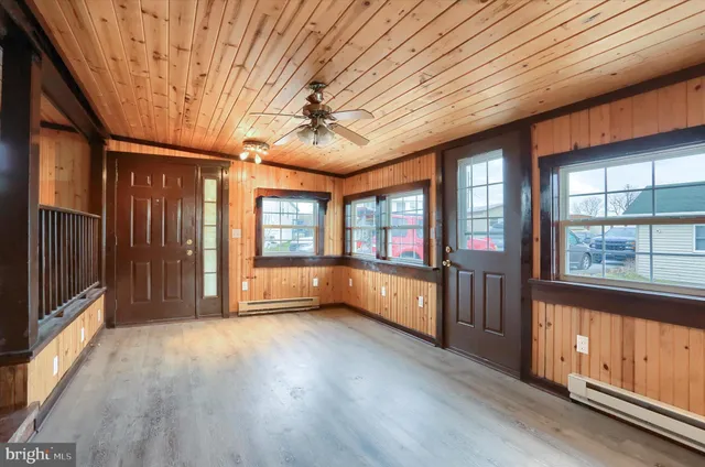 a view of a livingroom with wooden floor and stairs