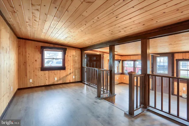 a dining room with furniture window and wooden floor
