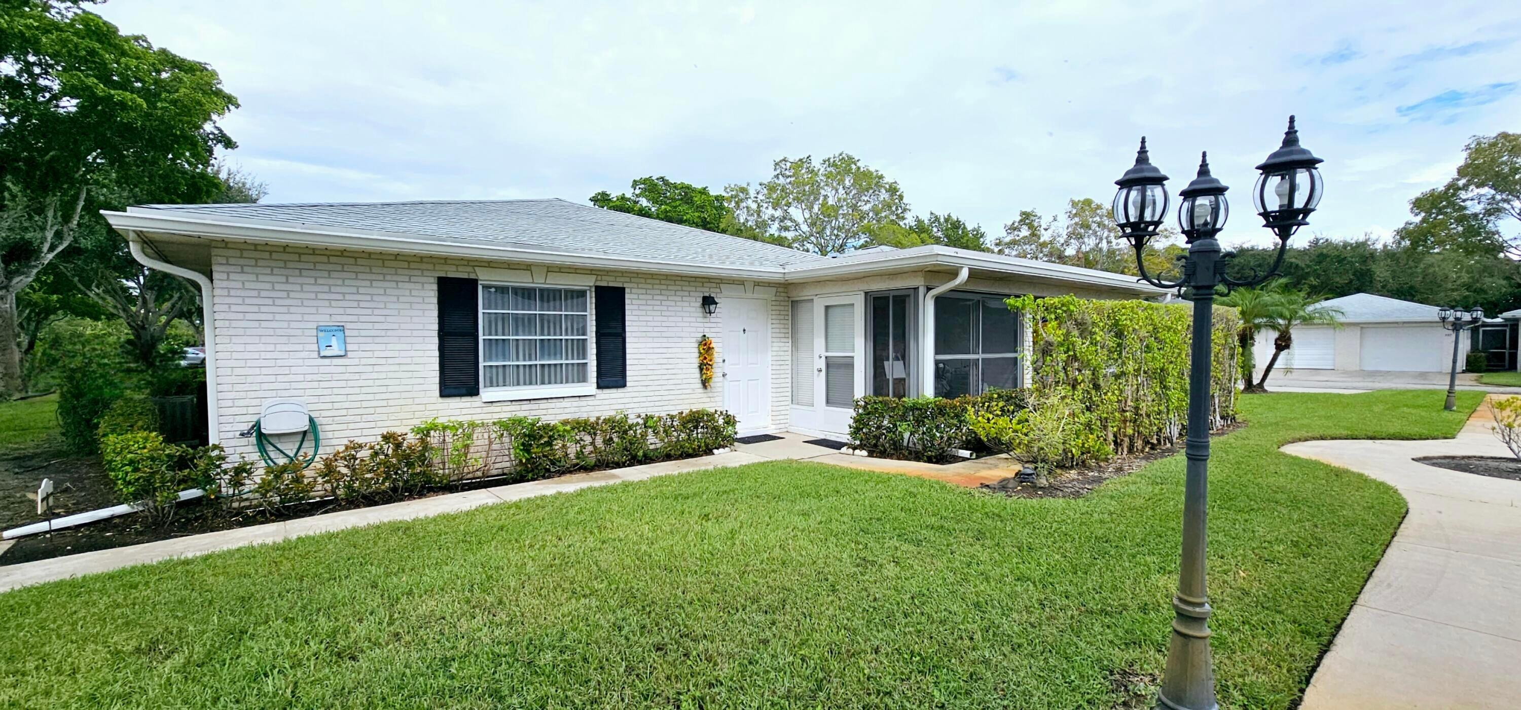 10126 South 44th Terrace Boynton Beach, FL 33436 - Photo 1 of 30 a front view of house with yard and green space