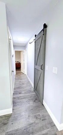 a view of a hallway view with wooden floor and staircase
