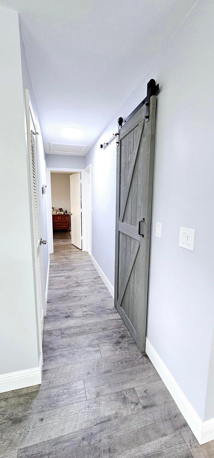 10126 South 44th Terrace Boynton Beach, FL 33436 - Photo 12 of 30 a view of a hallway view with wooden floor and staircase